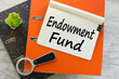 ENDOWMENT FUND text on notepad with pen, business concept. magnifying glass on orange tape
