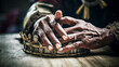 Touching close-up of African village chief's hands setting traditional crown on wooden table.