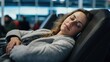 © Aidas - Peaceful traveler taking a nap in airport lounge, embracing tranquility and serenity. Soft, warm lighting accentuates relaxed body and closed eyes. Canon EF 50mm f/1.2L USM lens captures restful mood