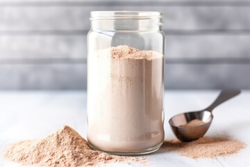 Poster - protein powder in a clear glass jar with scoop