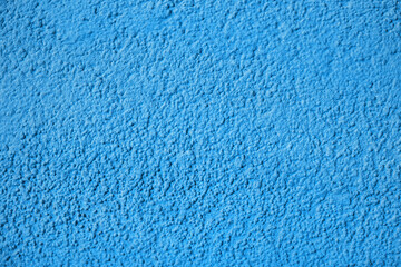 Wall Mural - Home facade texture. Blue rough surface. Grunge grain. Crushed rocks in the wall. Exterior home decoration. Stucco wall pattern. Blue color retro design. Noisy design background.