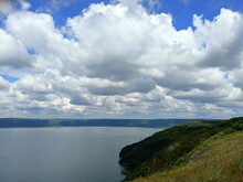 View From The Slope Of The Hill Covered With Abundant Green Vegetation On The Wide Channel Of The Dniester Under Snow-white Summer Clouds.