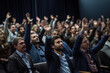 © Bojan - Raised hands and arms of large group of people at conference, audience voting in professional education surrounding.