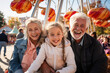 Grandparents and grandchildren enjoying a day at an amusement park, experiencing thrills and laughter together, love and creation