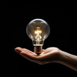 © pkproject - Illuminating Ideas: Hand Cradles a Glowing Light Bulb, Symbolizing Creativity and Innovation