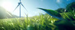 Close-up of a green grass field with a wind turbine on the background representing clean renewable energy, alternative power production and net zero carbon emissions.