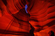 Navajo girl staring at moon through slot at Antelope Canyon at night