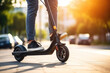 Close up of person riding electric scooter at the street