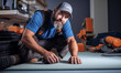 portrait of Carpet Installer, who Lays and installs carpet from rolls or blocks on floors, Installs padding and trim flooring materials