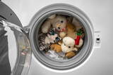 Fototapeta Desenie - Washing soft toys in the washing machine along with laundry.