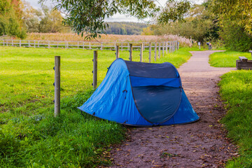 Wall Mural - Blue tourist tent aside of walking pass at countryside area. Sweden.