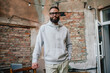 © San4ezz007 - Urban Portrait of Handsome Hipster Man with a Beard Wearing a Gray Blank Hoodie with Space for your Logo or Design. Unique Mockup for Print