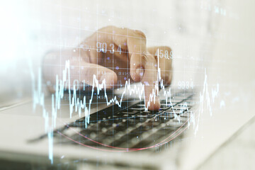 Double exposure of abstract creative financial chart with hand typing on computer keyboard on background, research and strategy concept