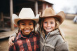 Two cowgirls of African-American and European appearance in cowboy hats look at the camera and smile
