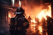 firefighters wearing full equipment fighting against fire in a burning building in the city