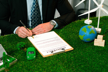 Businessman or CEO in office signing environmental regulation agreement to save Earth with sustainable energy utilization and CO2 reduction for greener future. Quaint