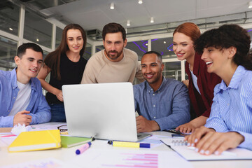 Wall Mural - Team of employees working together at table in office. Startup project