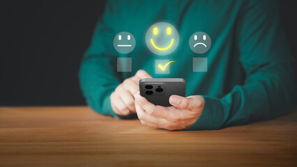 Poster - User hand using a mobile phone with pop up smile face icon for feedback review satisfaction service opinion and testimonial. Customer service experience assessment and business satisfaction survey.