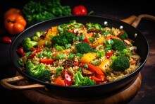 quinoa and vegetable stir fry on a cooking pan