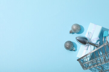 Metal butt plug with gifts on a blue background.