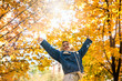 © RomanR - smiling young woman enjoy sunny weather at autumn park