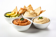 Presentation Of Various Kinds Of Gourmet Hummus With Pita Chips Isolated On White Background 