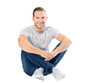 © Photocreo Bednarek - Casual young man sitting and smiling isolated and cut out on transparent white background