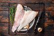 Raw red perch fillet, redfish fish meat in a steel tray. Wooden background. Top view