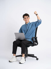 Wall Mural - Full body of young Asian man using laptop on white background