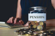 Woman calculate pension for retirement plan with jar of coin, Saving, fund , investment.