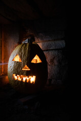 Wall Mural - scary Halloween pumpkin glowing in window at night