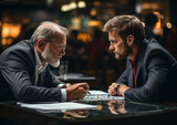 Fototapeta  - dwóch mężczyzn w garniturach rozmawiających, negocjujących przy stole.