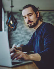Caucasian student watching webinar on laptop computer improving skills on programming