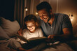 caucasian dad reading a book to his daughter before bedtime