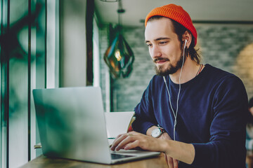 Wall Mural - skilled freelancer enjoying remote job typing publication for web blog on laptop