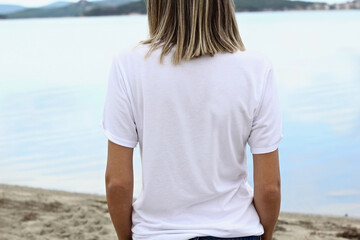 Wall Mural - Back White t shirt mockup with copy space. Woman's blank white tshirt template with lake background