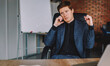© BullRun - Serious male owner of corporation talking on mobile phone during working process in office