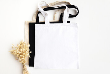 Wall Mural - White, black, beige tote bags mockup on a white background. Colored tote bags mock ups