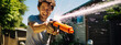 © Studio Nova - Man playing with a water gun in his front yard on a warm summer afternoon