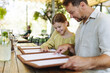© Halfpoint - Father and daughter reading menus in a restaurant, choosing food and drinks.