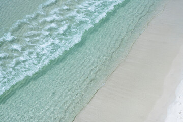 Aerial view Destin, Florida, white sand beach on a bright sunny day on the Gulf of Mexico clear emerald waters 