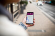 © Marko Geber - Close up of a young woman using her smartphone to navigate through the city