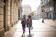 © Marko Geber - Young mixed lesbian couple embracing each other while shopping and walking in the city