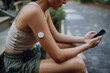 © Halfpoint - Beautiful diabetic woman preparing for outdoor workout in the city.