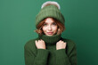 © wolfhound911 - Frozen young woman in winter clothes on green background