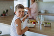 © Halfpoint - Diabetic boy with a continuous glucose monitor is careful with his diet.
