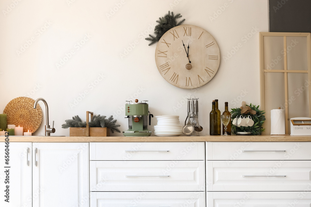 White kitchen counters with utensils and Christmas decor