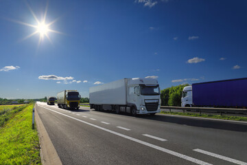 Cargo truck driving through landscape at sunset