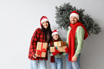 Poster - Happy family with Christmas tree and presents on light background