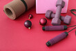 Leinwandbild Motiv Sports equipment with Christmas decor on red background, closeup
